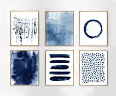 four blue and white paintings hanging on the wall