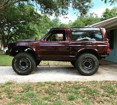 a red pick up truck parked in front of a house