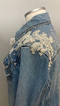 the back of a jean jacket with beading on it