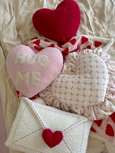 pillows, envelopes and hearts on a bed