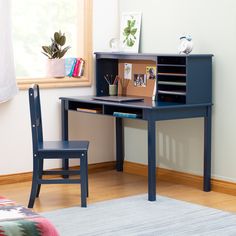 a small desk with a chair next to it and a window in the back ground