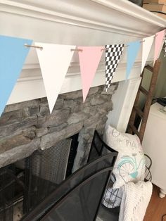 a fireplace with bunting flags hanging from it's mantle