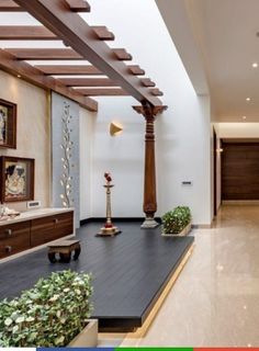 a living room filled with lots of furniture next to a wooden ceiling mounted on the side of a wall