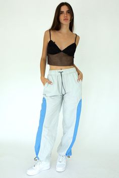 Introducing the Delilah Track Pant. The perfect sporty-chic fashion piece for when you need to look as cool as you feel! Featuring a bungee waist and elastic ankle, they'll hug all the right places while staying true to comfort. These pants can take you from a relaxed day at home to a fun night out, so go ahead, take a few laps around the style circuit - she's made for it! Woven with Pull-On Elastic Waist Casual Chic 86% Nylon 14% Spandex Model is 5'8 and wearing size SMALL Sporty Chic Style, Going Out Looks, Corsets And Bustiers, Track Pant, Budget Fashion, Denim Details, Sporty Chic, Chic Fashion, Soho