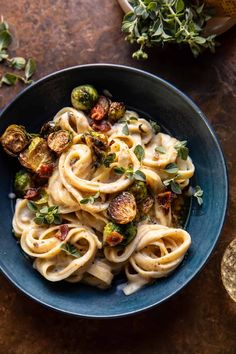 pasta with brussel sprouts and brussels sprouts in a blue bowl