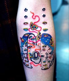 a woman's leg with tattoos on it and an image of two women in the middle