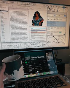 a person is holding a coffee mug in front of a computer screen with the image of a woman on it