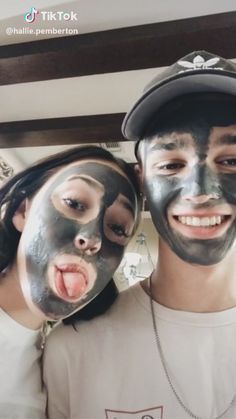 two people with black masks on their faces