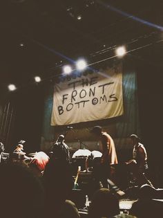 two men are standing on stage with microphones in front of them and a banner that says the front bottoms