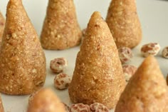 several pieces of food that are on a plate with nuts in the middle and one is shaped like a cone