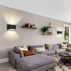 a living room filled with furniture and lots of windows