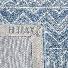 blue and white rugs with the name valeh written on one side in grey