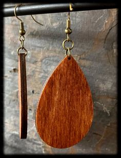 Whimsical Pumpkin Earrings are made of wood and engraved with a swirled pumpkin design. These are stained with two colors to blend together the perfect autumn color. The earrings dangle with antique bronze hypoallergenic hooks and are extremely lightweight. - Wooden Earring is 1.8 inches long (not including hook and jump rings). - Each pair will be made as shown in the example and sealed (stained wood grain could vary slightly with each pair) Brown Wooden Dangle Jewelry, Handmade Teardrop Natural Wood Jewelry, Handmade Natural Wood Teardrop Jewelry, Brown Teardrop Wood Jewelry, Teardrop Wooden Earrings For Gifts, Teardrop Wood Earrings For Gifts, Wooden Teardrop Earrings As Gift, Wooden Teardrop Earrings For Gift, Artisan Brown Wooden Earrings