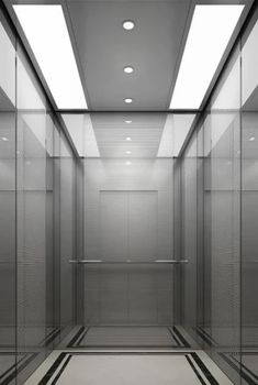 an empty room with glass walls and flooring in the center is lit by recessed lights