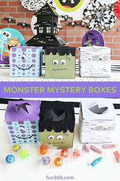 some paper boxes that are decorated to look like monsters with the words monster mystery boxes on them