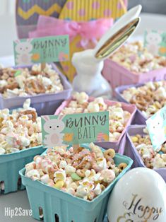 there are many small containers filled with food on the table and one has a sign that says bunny ball