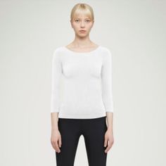 The Classic Cordoba Pullover Has Been Rejuvenated And Refined For Our New Collection. The Subtle Shimmer Of The Opaque Natural Material Is An Organic Attention Grabber And Its Form Fit Design Will Flatter Your Figure. The ¾ Sleeve Length And Neckline Featuring A Semi-Sheer Elastic Band Blend A Casual Appearance With An Exceptional Feel. Cordoba Is A Casual Option That Is Far From Ordinary. Form Fit / Opaque Natural Material / Shimmering / ¾ Sleeve Length / Neckline With Semi-Sheer Elastic Band / Classic Stretch Textured Knit Tops, Classic Winter Tops With Minimal Stretch, Classic Tops With Minimal Stretch For Winter, White Workwear Tops, Classic Long Sleeve Stretch Knit Top, Classic Stretch Knit Top With Long Sleeves, Versatile Fitted White Sweater, Wolford Bodysuit, Lace Sleeveless Top