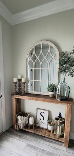 a wooden shelf sitting next to a white door with a mirror on top of it