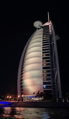 the burj building is lit up at night