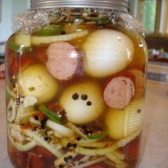 a jar filled with lots of food on top of a table