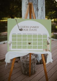 a wooden easel holding a sign that says guess james's duee date