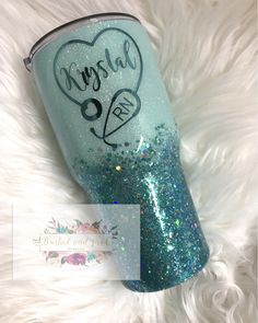 a blue glitter tumbler with the words crystal on it and a heart in the middle