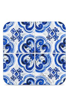 a blue and white tile design with swirls on the bottom, in square shape