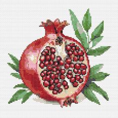 a cross stitch pomegranate with leaves on it