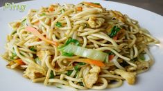 a white plate topped with noodles and vegetables