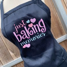 the back of a woman's black apron with just baking memories printed on it