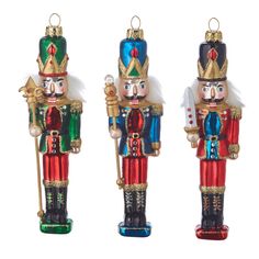 three nutcrackers are standing next to each other in different colors and sizes