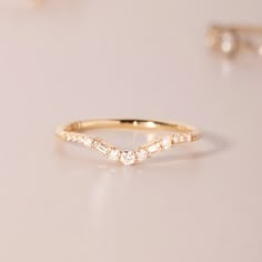 a gold ring with three diamonds on it