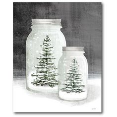 two glass jars with christmas trees in them