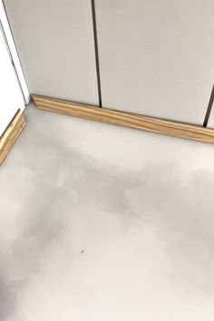 the floor is white and dirty in this bathroom