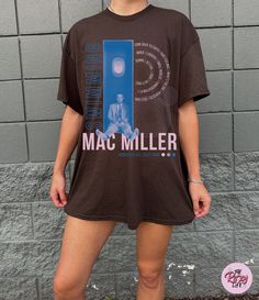 "Hey, Mac Miller fans - are you ready to take a stylish dive into the world of music and art? We've got the tee that'll make you feel like you're \"Swimming in Circles\" with your favorite artist, in a fresh, modern, and pastel-tastic way! 💙 Artistic Euphoria: This tee is more than just clothing; it's a wearable masterpiece. Inspired by Mac Miller's iconic \"Swimming\" album, our design takes a minimalist twist, blending pastel shades of blue, pink, and purple. The tracklist creates a rhythmic vibe, while the concentric circle motif ties in with Miller's \"Circles\" album, completing the idea of endless musical flow. 🌟 Unmatched Comfort: Made from 100% ring-spun cotton, this lightweight (4.5 oz/yd² or 153 g/m²) unisex t-shirt is like a musical hug for your skin. The classic fit and crew Mac Dre T Shirt, Mac Miller Shirt, Mac Miller Merch, Hip Hop Tshirt, Music And Art, Favorite Artist, Mac Miller, Shirts Design, Pastel Shades