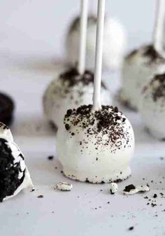 oreo cake pops with white frosting and chocolate sprinkles on top