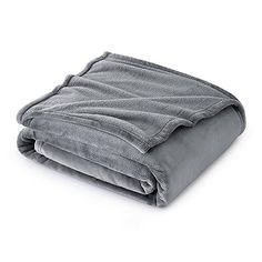 a gray blanket folded on top of a white surface