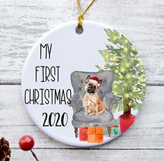 a ceramic ornament with a dog sitting on a chair next to a christmas tree