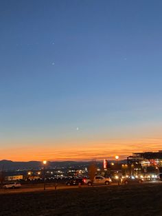 cars are parked in the parking lot at dusk