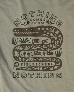 there is a t - shirt with an image of a snake and words on it