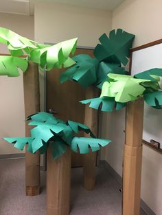 some very pretty paper trees in a room