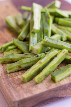 green beans are cut up on a cutting board