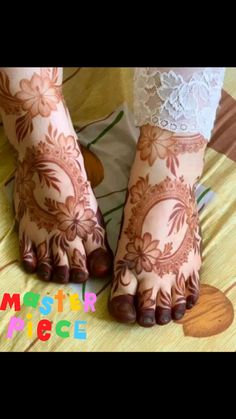 the feet are decorated with henna and lace