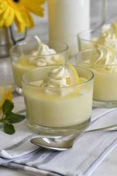 three glasses filled with dessert sitting on top of a table