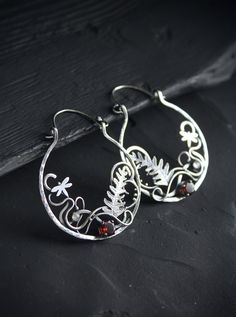 ITEM DESCRIPTION: Size H 6 x W 4 cm (2 1/2 x 1 1/2 inches) with closure. Wire earrings are very lightweight and comfortable for your ears. Weight - 5 g of each other. These unique circle earrings look like a piece of wild magic forest with fern leaves and dragonflies. I made them of sterling silver, natural garnet, and tiny labradorite. Statement botanical earrings will come to you in a gift box - ready for gifting. You can order these unique hoop earrings this different stones. Please write to Handmade Silver Botanical Earrings, Silver Nature-inspired Hoop Earrings As Gift, Silver Nature-inspired Hoop Earrings For Gift, Nature-inspired Hoop Earrings As Gift, Nature-inspired Round Hoop Earrings For Gift, Handmade Leaf-shaped Botanical Jewelry, Handmade Small Hoop Earrings, Nature-inspired, Handmade Small Hoop Earrings Nature-inspired, Nature-inspired Dangle Hoop Earrings As Gift