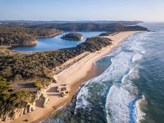 an aerial view of the beach and ocean with several small islands in the water, surrounded by trees