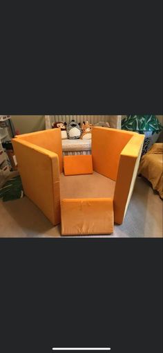 an orange chair sitting on top of a carpeted floor