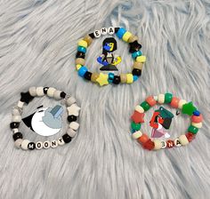 ENA-Inspired Kandi Pony Bead Bracelets Perfect for fans of the animated YouTube series/upcoming video game, ENA and Dream BBQ! Perfect for Christmas, birthdays, or any occasion like a fun surprise for the video game release! Includes 2 Versions of ENA: Season 1, depicted in blue and yellow; and Season 2, depicted in red and pale yellow; Moony, the Shepherd, Merci, and Phindoll.  Many of the beads are UV reactive so there will be a fun surprise under UV and blacklights! Each of the bracelets shown is around 6 inches. Please measure yourself to find your wrist size. If your size isn't an option, put it in the personalization!  I use mostly pony beads but some bracelets have glass or resin beads. I take artistic liberties and hand-make every bracelet so you may not receive the exact bracelet Themed Beaded Bracelets With Round Beads As Gift, Handmade Themed Stretch Bracelet With Round Beads, Themed Handmade Beaded Bracelets With Round Beads, Handmade Themed Beaded Bracelets With Round Beads, Beaded Themed Stretch Bracelet For Friendship, Themed Handmade Beaded Bracelets, White Themed Beaded Bracelet, Handmade Themed Beaded Bracelets, Handmade Novelty Stretch Bracelet With Round Beads