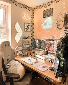 a computer desk topped with lots of clutter next to a window covered in lights