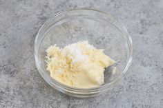 a glass bowl filled with cream on top of a counter